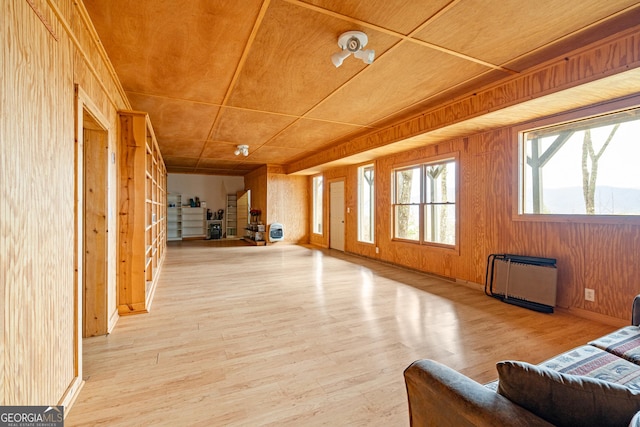 living room featuring wood walls and wood finished floors