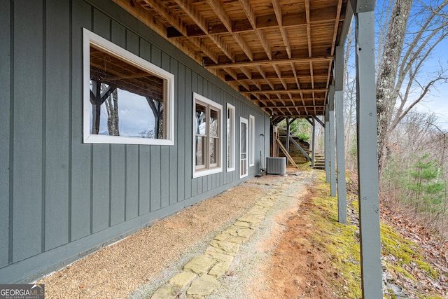 view of side of home with central air condition unit and board and batten siding