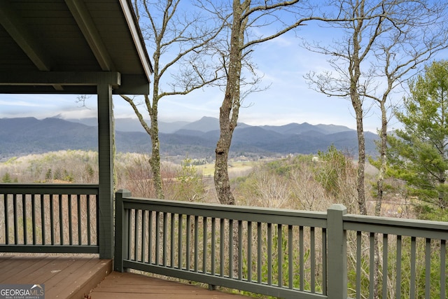 wooden deck with a mountain view