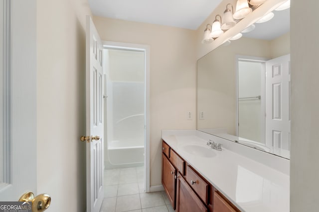 full bathroom with tile patterned floors, baseboards, a tub, and vanity