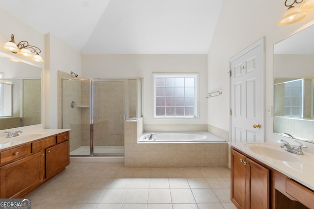 full bath featuring lofted ceiling, a shower stall, two vanities, and a sink