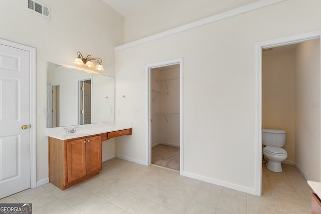 bathroom featuring baseboards, visible vents, vanity, and toilet