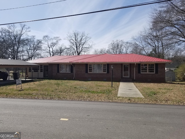 ranch-style home featuring crawl space, metal roof, a front lawn, and brick siding