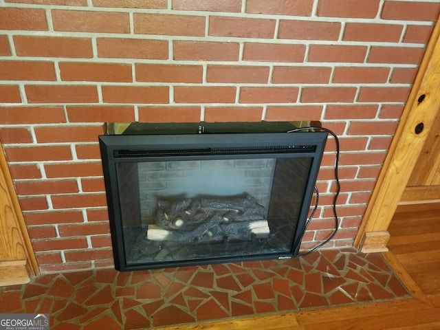 interior details with a glass covered fireplace