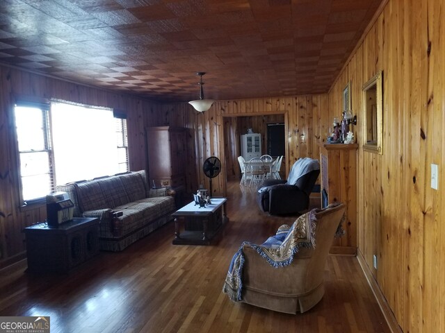 living area featuring wood walls and wood finished floors