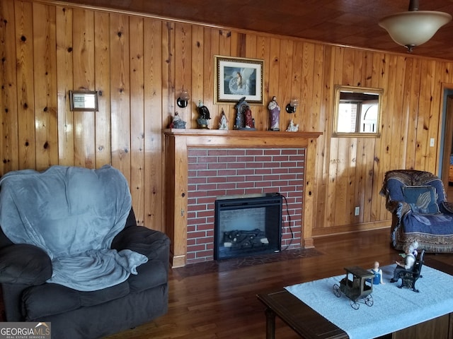 living room featuring a brick fireplace and wood finished floors
