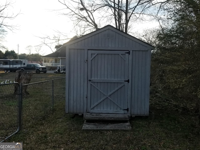 view of shed with fence