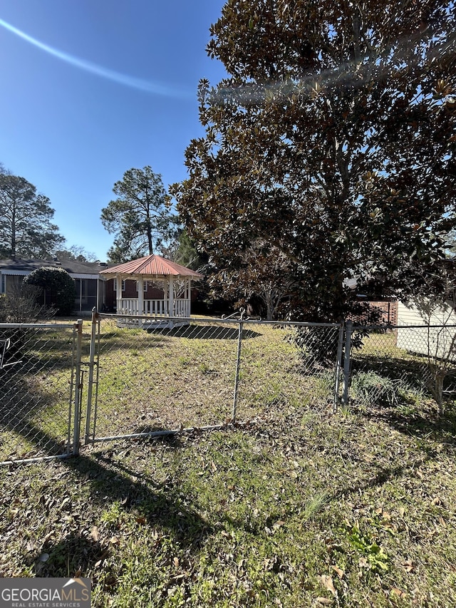 view of yard with a gazebo and fence