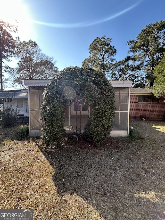 rear view of house with an outdoor structure