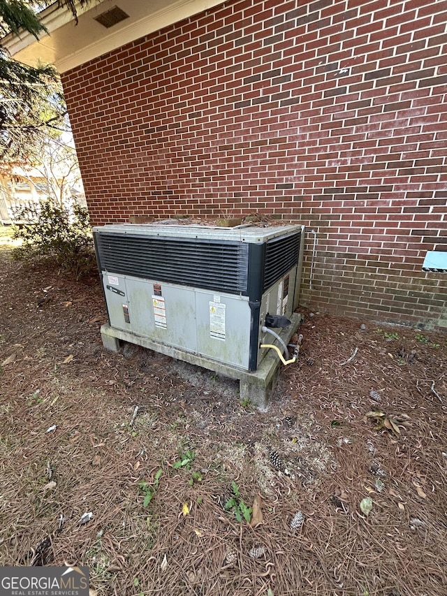 exterior details featuring central air condition unit and brick siding