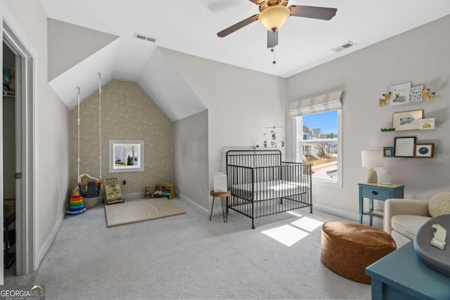 sitting room featuring lofted ceiling, a ceiling fan, visible vents, baseboards, and carpet