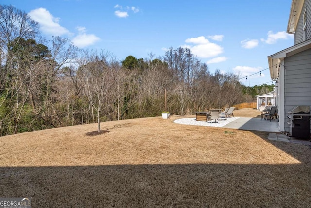 view of yard featuring a fire pit and a patio