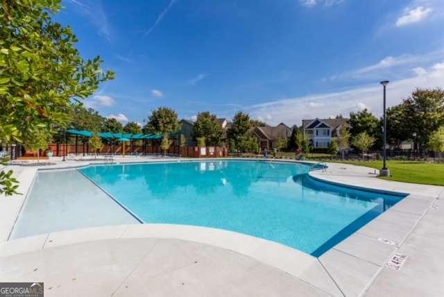 pool featuring a patio area and fence