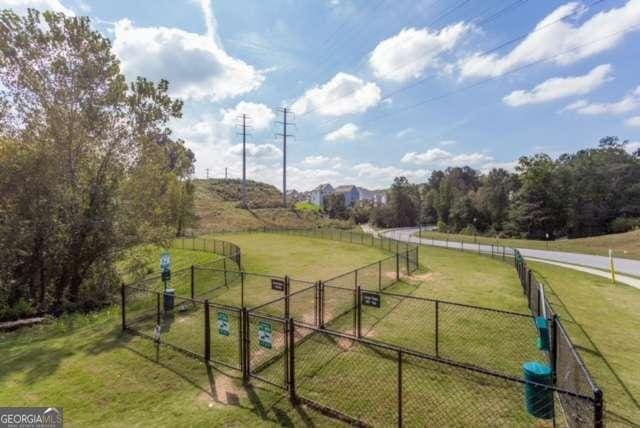 exterior space with a rural view, fence, and a gate