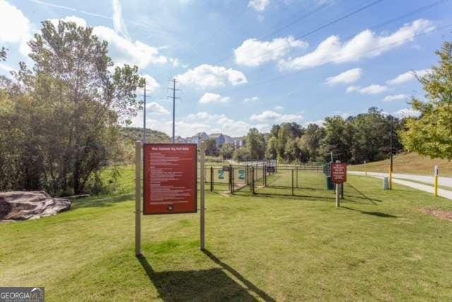 view of community with a yard and fence