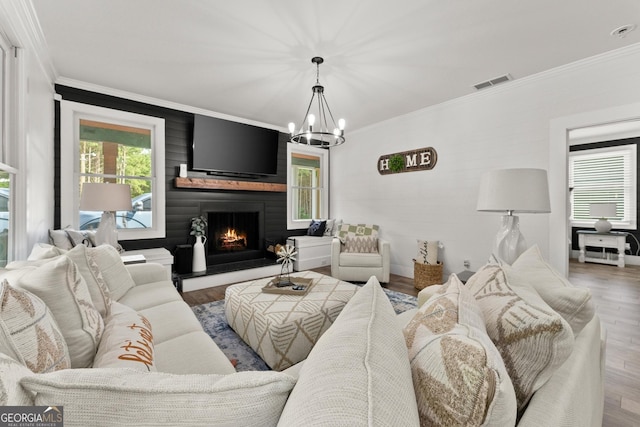 living room featuring plenty of natural light, visible vents, and ornamental molding