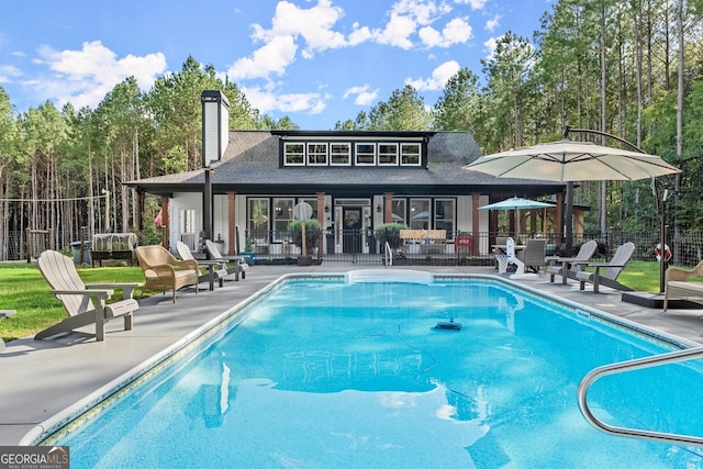 view of swimming pool featuring a patio, fence, and a fenced in pool