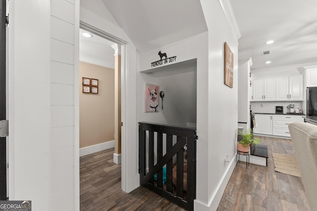 corridor with crown molding, recessed lighting, dark wood finished floors, and baseboards