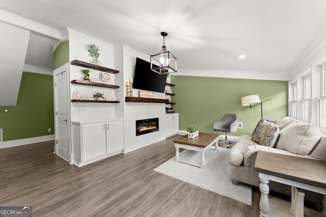 living area with a fireplace, an inviting chandelier, ornamental molding, wood finished floors, and baseboards