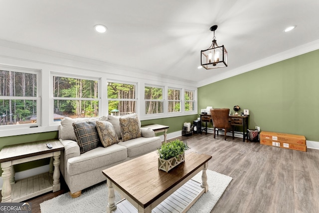 sunroom / solarium with a baseboard radiator and a notable chandelier