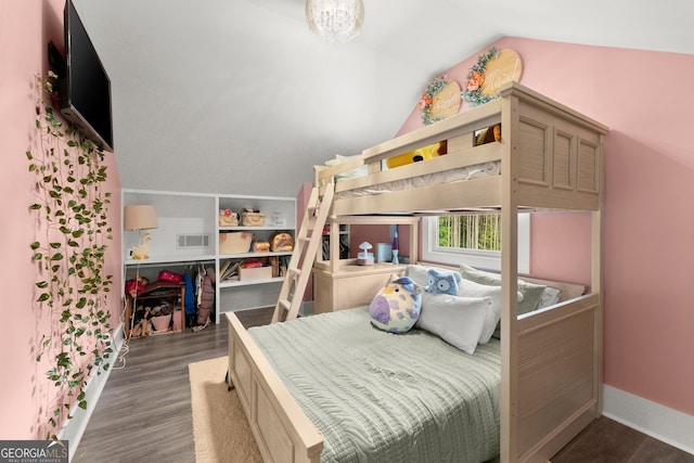 bedroom featuring lofted ceiling, baseboards, visible vents, and wood finished floors