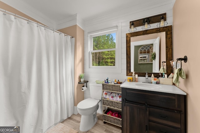 full bathroom with crown molding, vanity, toilet, and wood finished floors