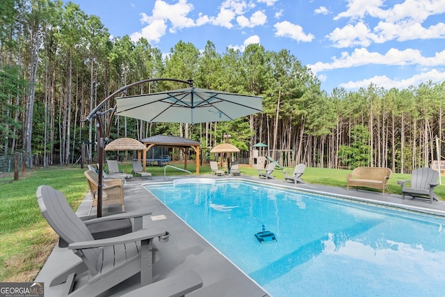 view of swimming pool with a gazebo, a yard, fence, and a fenced in pool