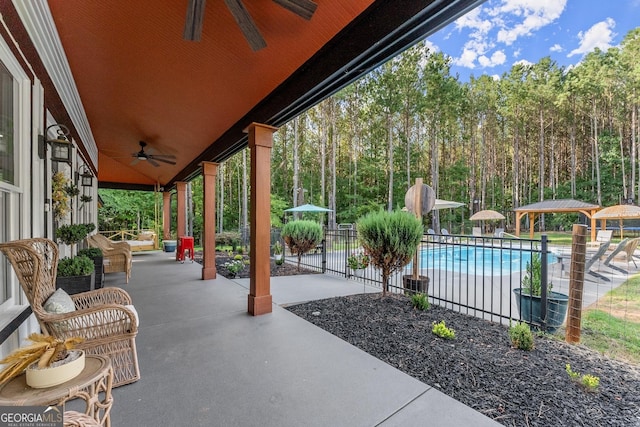 view of patio / terrace with a fenced in pool, ceiling fan, a gazebo, and fence