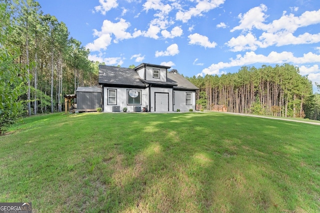 view of front of house featuring central AC and a front lawn