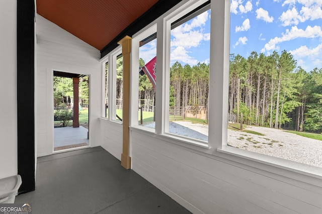 unfurnished sunroom featuring lofted ceiling