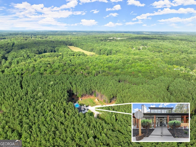 birds eye view of property with a forest view