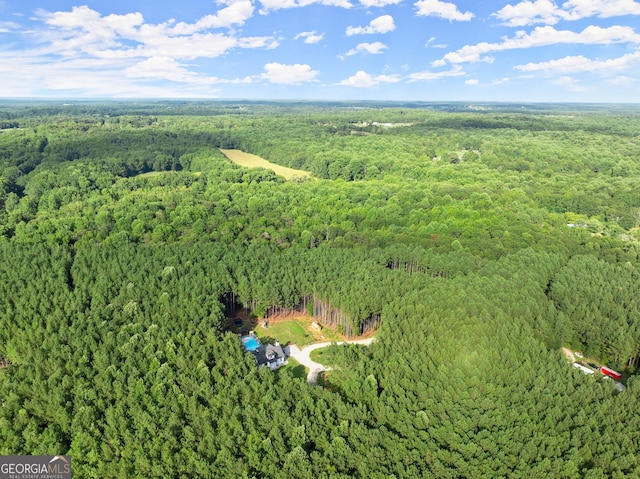 birds eye view of property with a wooded view