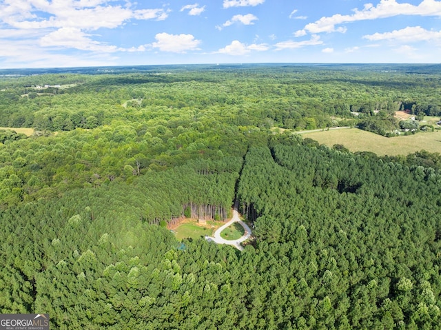 aerial view featuring a wooded view