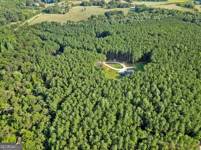 birds eye view of property with a view of trees