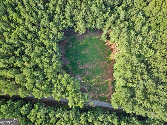 bird's eye view featuring a wooded view