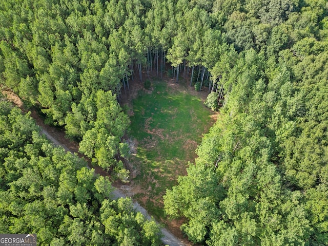 bird's eye view featuring a wooded view