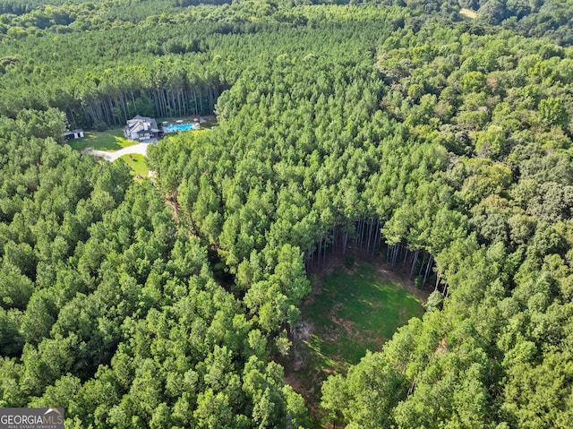 birds eye view of property with a forest view