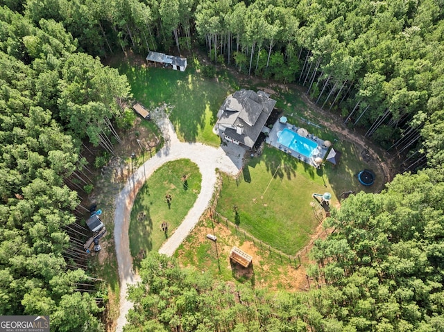 drone / aerial view featuring a forest view