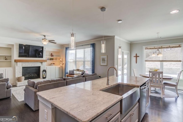 kitchen featuring dishwasher, dark wood-style floors, ornamental molding, open floor plan, and a sink