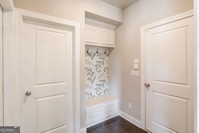 mudroom with dark wood-style floors and baseboards