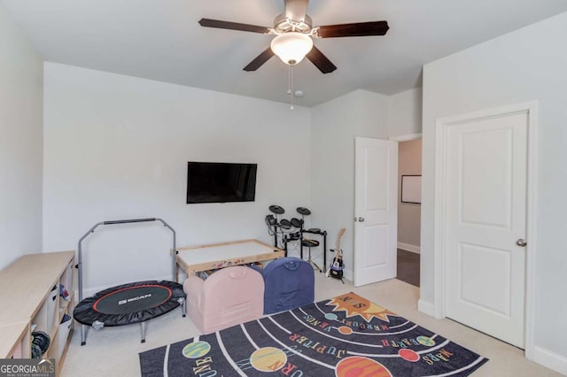 interior space featuring baseboards, a ceiling fan, and carpet flooring