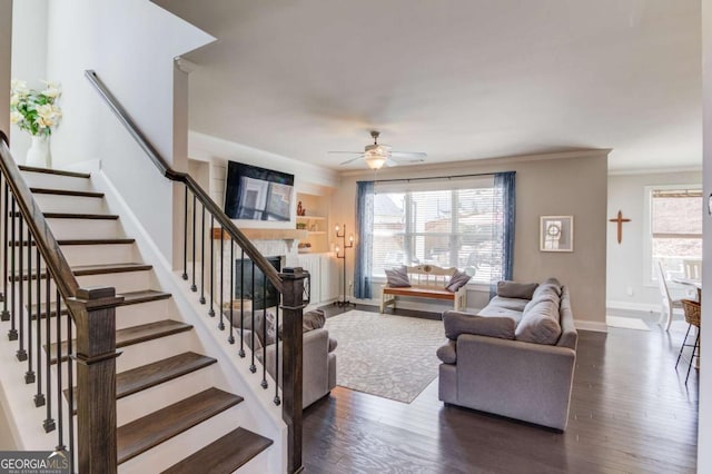 living area featuring dark wood-style floors, ornamental molding, stairs, and baseboards