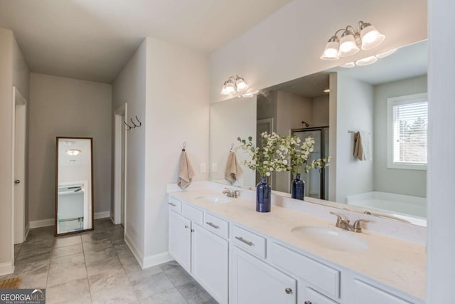 full bath featuring double vanity, a shower stall, a sink, and a bath