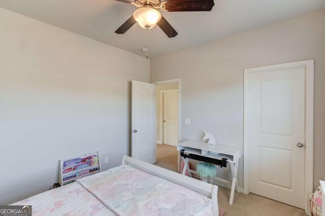 bedroom featuring light colored carpet and ceiling fan