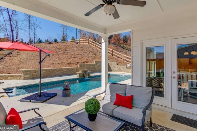 pool featuring fence, a ceiling fan, and a patio