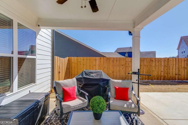 view of patio / terrace with a grill, fence, and ceiling fan