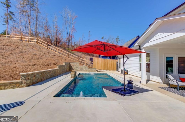 view of swimming pool with a fenced backyard, a fenced in pool, and a patio