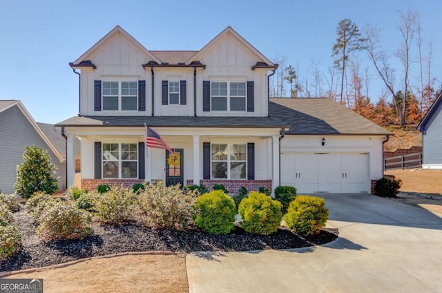 craftsman-style home with concrete driveway, brick siding, board and batten siding, and an attached garage