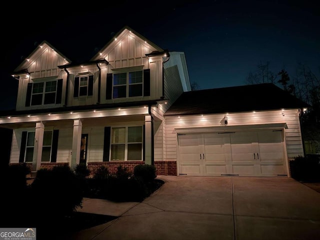 craftsman-style home with board and batten siding, brick siding, driveway, and an attached garage