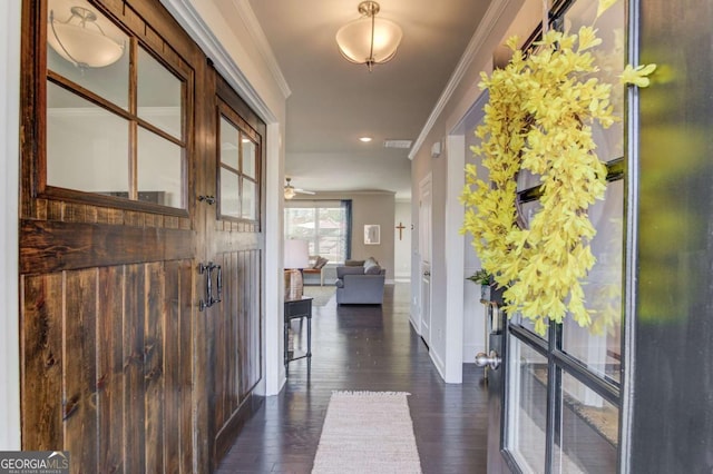 interior space featuring baseboards, ornamental molding, and dark wood finished floors